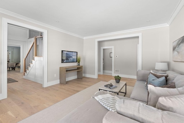 living room with light hardwood / wood-style flooring and crown molding