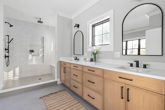 bathroom featuring vanity, tile patterned flooring, crown molding, and a tile shower