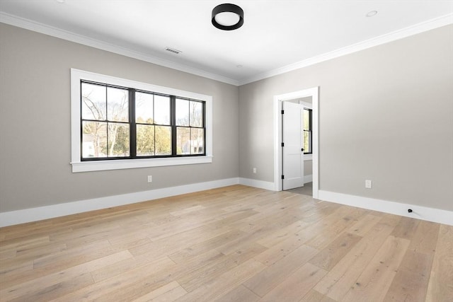 unfurnished room featuring crown molding and light hardwood / wood-style floors