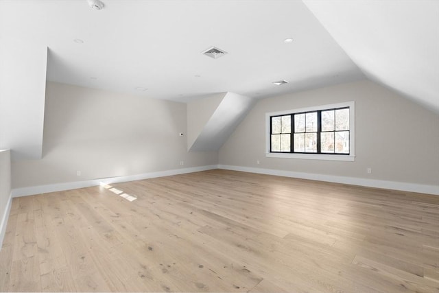 bonus room featuring light hardwood / wood-style flooring and vaulted ceiling