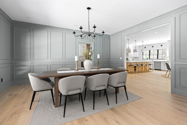 dining room featuring light hardwood / wood-style flooring and a notable chandelier