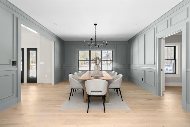 dining space featuring a chandelier and light hardwood / wood-style floors