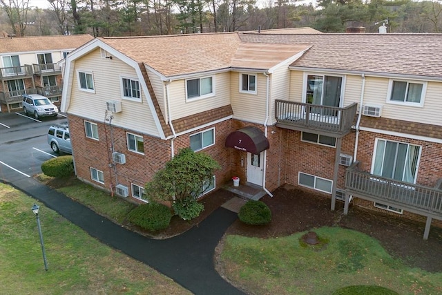 view of property with an AC wall unit