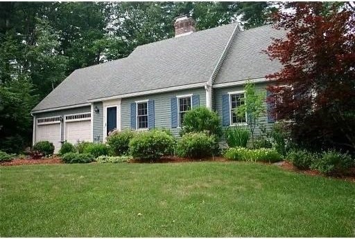 8 Caleb Rd, Shirley, MA 01464 - view of front of house with a garage, a chimney, and a front lawn