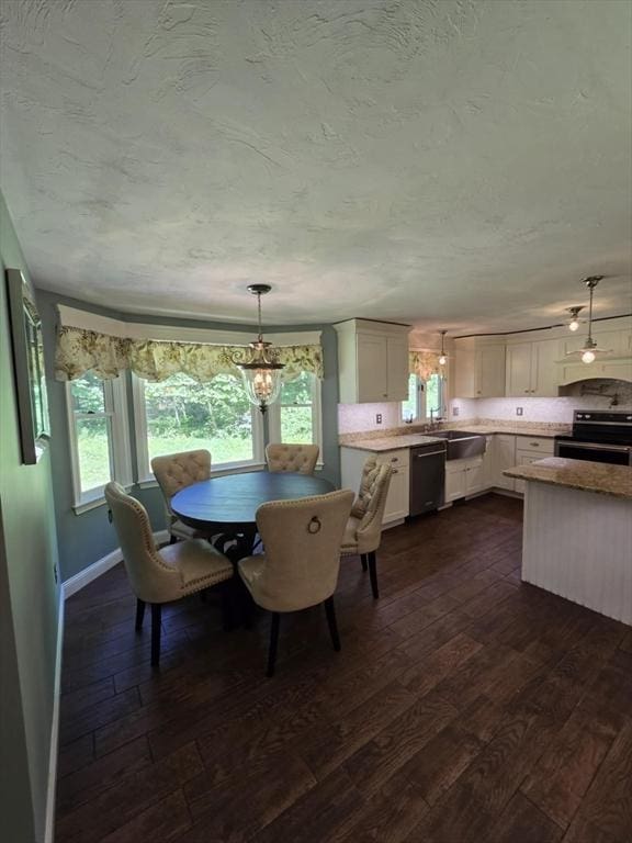 8 Caleb Rd, Shirley, MA 01464 - dining space with dark wood-style flooring, a chandelier, and a textured ceiling