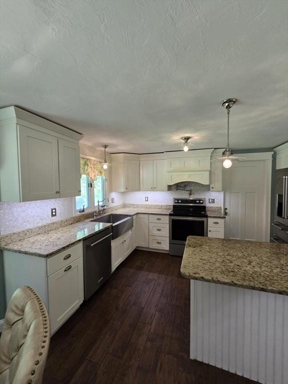 8 Caleb Rd, Shirley, MA 01464 - kitchen with stainless steel appliances, dark wood-type flooring, white cabinetry, light stone countertops, and a textured ceiling