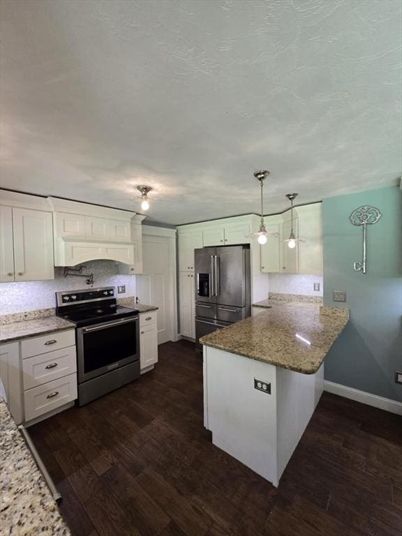 8 Caleb Rd, Shirley, MA 01464 - kitchen featuring appliances with stainless steel finishes, a peninsula, dark wood-type flooring, white cabinets, and light stone counters