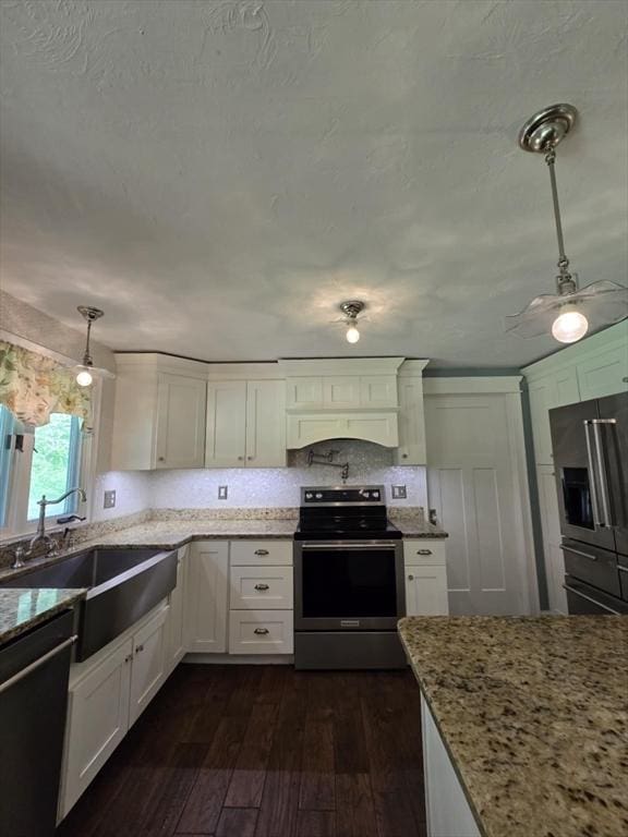 8 Caleb Rd, Shirley, MA 01464 - kitchen featuring appliances with stainless steel finishes, dark wood-style flooring, white cabinetry, and light stone counters