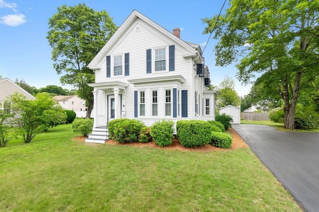 7 Martin St, Danvers, MA 01923 - neoclassical home with a chimney, a front yard, driveway, and an outbuilding