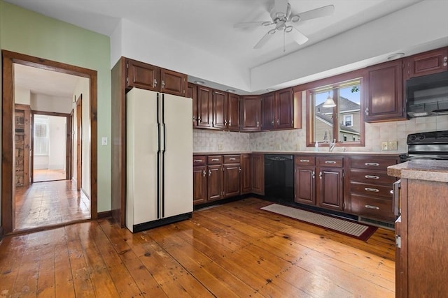 7 Martin St, Danvers, MA 01923 - kitchen featuring black appliances, dark wood-style flooring, backsplash, a ceiling fan, and light countertops