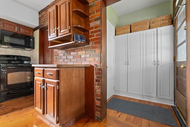 7 Martin St, Danvers, MA 01923 - kitchen with black appliances, light wood finished floors, and brown cabinets