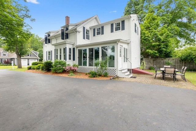 7 Martin St, Danvers, MA 01923 - back of property featuring entry steps and a chimney