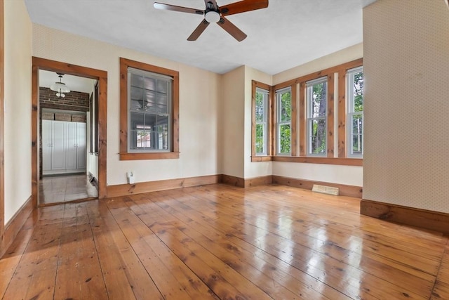 7 Martin St, Danvers, MA 01923 - unfurnished room featuring wood-type flooring, wallpapered walls, and ceiling fan