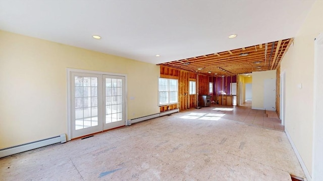 unfurnished room featuring a baseboard heating unit, recessed lighting, and visible vents