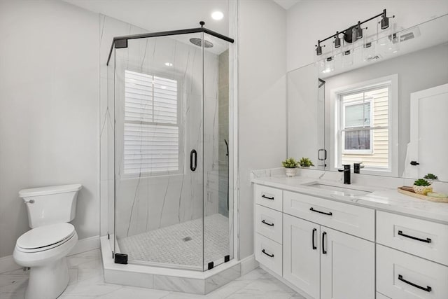 bathroom featuring marble finish floor, a marble finish shower, toilet, vanity, and baseboards