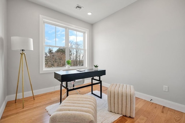 office area with light wood finished floors, baseboards, visible vents, and recessed lighting