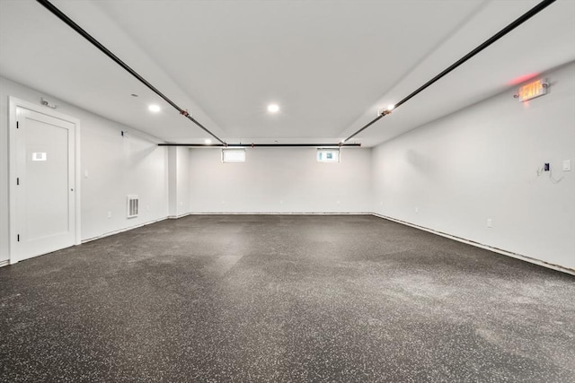 empty room with visible vents and speckled floor