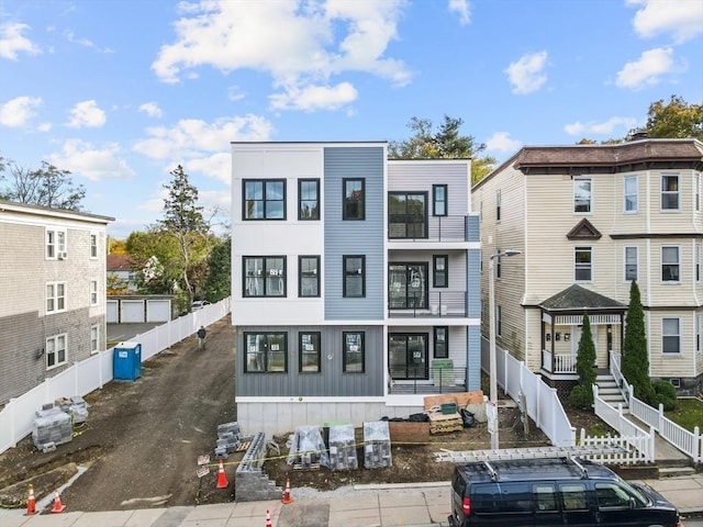 view of front facade featuring board and batten siding and fence