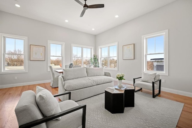 living area featuring light wood-type flooring, ceiling fan, baseboards, and recessed lighting