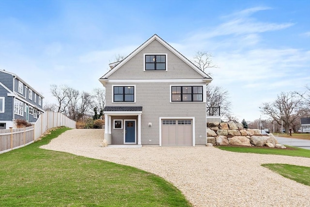 view of front of house featuring gravel driveway, a front yard, fence, and a garage