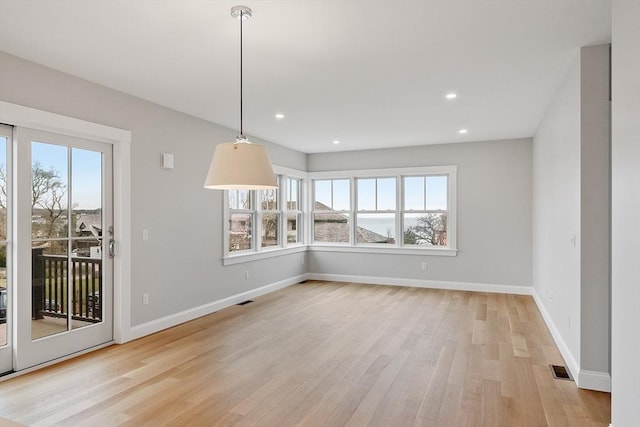 unfurnished dining area with visible vents, recessed lighting, baseboards, and light wood-type flooring