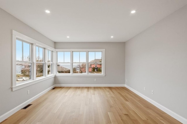 unfurnished room featuring recessed lighting, visible vents, baseboards, and light wood-style floors