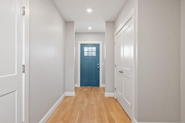 doorway with recessed lighting, light wood-type flooring, and baseboards