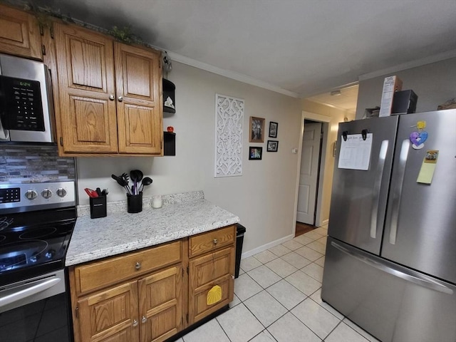 39 Cheever Rd, Malden, MA 02148 - kitchen with appliances with stainless steel finishes, crown molding, light tile patterned flooring, brown cabinets, and backsplash
