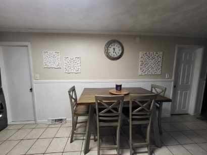 39 Cheever Rd, Malden, MA 02148 - dining area featuring light tile patterned floors, wainscoting, and ornamental molding