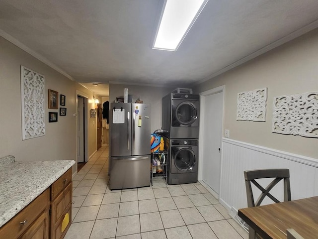 39 Cheever Rd, Malden, MA 02148 - laundry room featuring stacked washer / dryer, light tile patterned floors, wainscoting, and ornamental molding