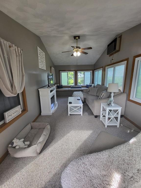 39 Cheever Rd, Malden, MA 02148 - living room with carpet, vaulted ceiling, ceiling fan, and a wall mounted AC