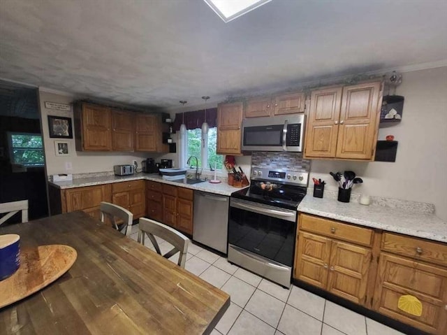 39 Cheever Rd, Malden, MA 02148 - kitchen featuring appliances with stainless steel finishes, open shelves, light countertops, light tile patterned flooring, and brown cabinets
