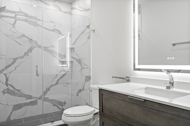 bathroom with a shower with shower door, toilet, and large vanity