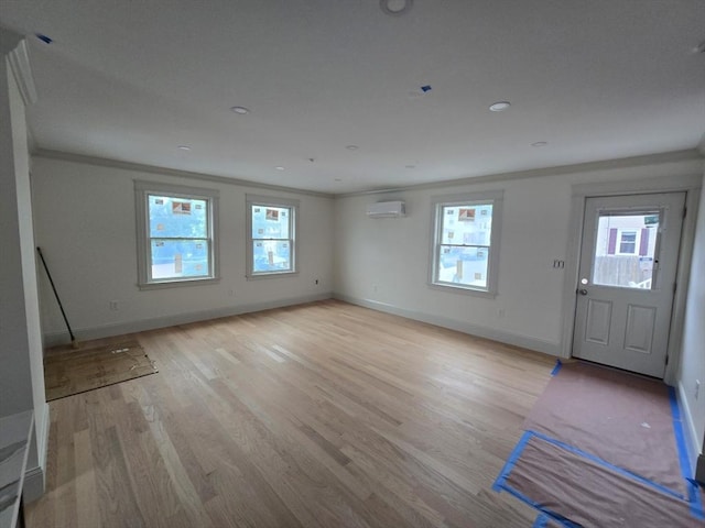 9 Swan St Unit 1, Beverly, MA 01915 - foyer entrance featuring light wood-type flooring, healthy amount of natural light, ornamental molding, and a wall unit AC