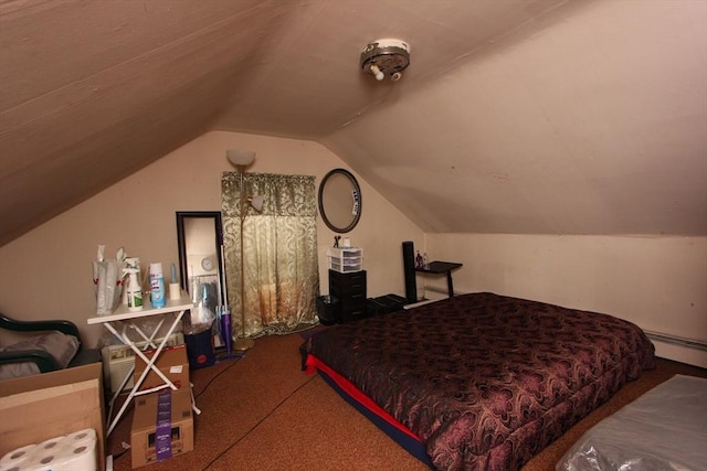 carpeted bedroom featuring baseboard heating and lofted ceiling