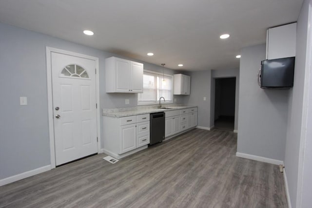 kitchen with pendant lighting, dishwasher, sink, light hardwood / wood-style floors, and white cabinetry