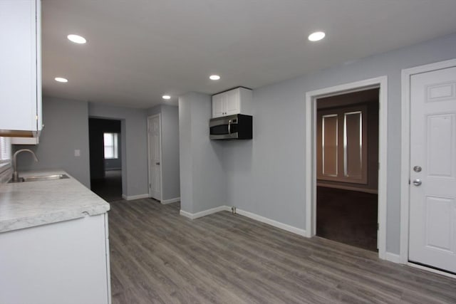 kitchen with white cabinets, dark hardwood / wood-style floors, and sink