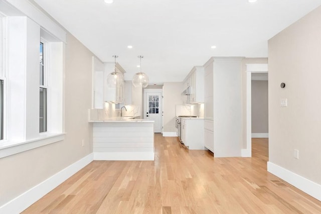 unfurnished living room with light wood-style floors, baseboards, and recessed lighting