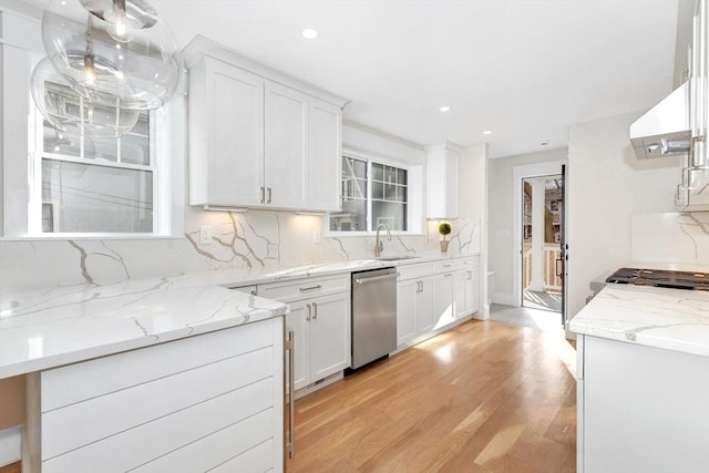 kitchen featuring dishwasher, hanging light fixtures, a sink, and white cabinets