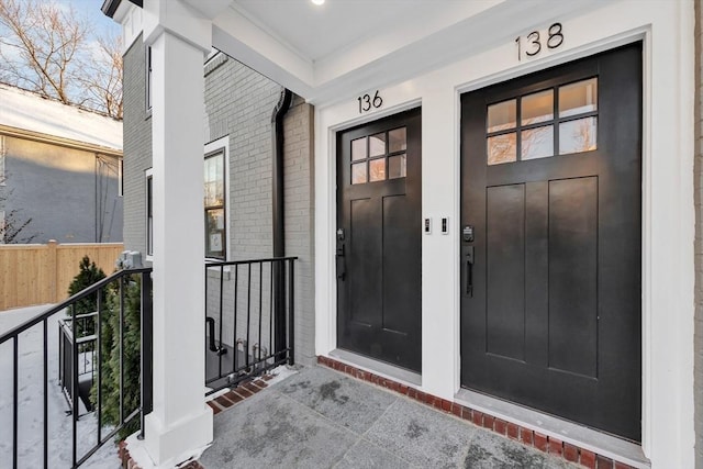 doorway to property featuring brick siding and elevator