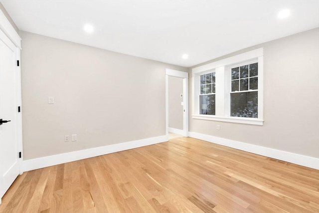 unfurnished room with recessed lighting, baseboards, and light wood finished floors