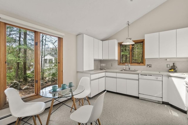 kitchen with white dishwasher, light countertops, white cabinets, tasteful backsplash, and a sink