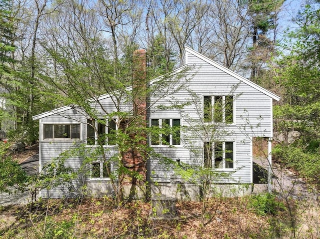 view of property exterior featuring a chimney