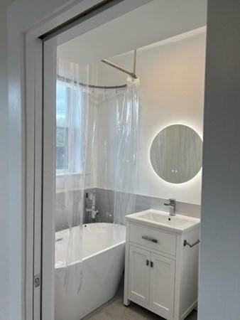 1258 Commonwealth Ave Unit 8, Boston, MA 02134 - full bathroom featuring a soaking tub, vanity, and a shower with shower curtain