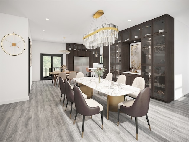 dining area featuring a chandelier, light wood-type flooring, and french doors