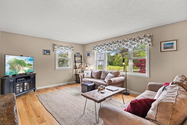 8 Stackpole Cir, Bourne, MA 02532 - living area with baseboards, light wood finished floors, and a textured ceiling