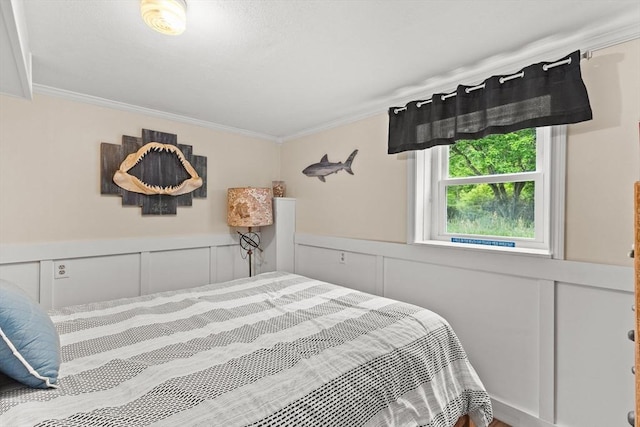 8 Stackpole Cir, Bourne, MA 02532 - bedroom featuring a decorative wall, crown molding, and a wainscoted wall