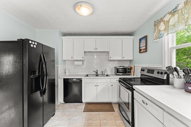 8 Stackpole Cir, Bourne, MA 02532 - kitchen featuring black appliances, a sink, light countertops, white cabinets, and a textured ceiling