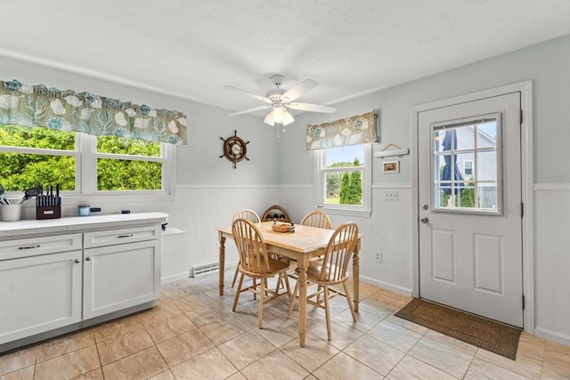 8 Stackpole Cir, Bourne, MA 02532 - dining room with wainscoting, ceiling fan, and a textured ceiling