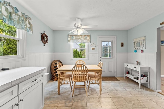 8 Stackpole Cir, Bourne, MA 02532 - dining room with a wainscoted wall and ceiling fan